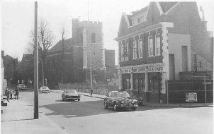 3 storey detached building with church in background 3 storey detached building with church in background