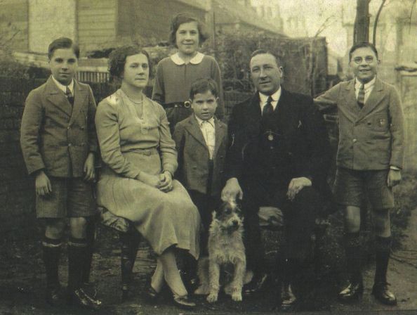 Photo taken in garden, parents and their four children and a dog Photo taken in garden, parents and their four children and a dog